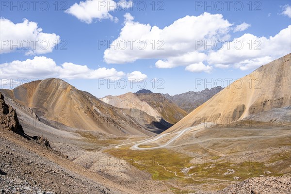 Mountain road through a colourful mountain landscape, view from the Chong Ashuu Pass, Tien Shan, Kyrgyzstan, Asia