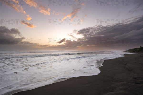 Dramatic cloudy sky at sunset on the beach, sandy beach on the Caribbean coast, Tortuguero National Park, Costa Rica, Central America