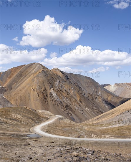 Mountain road through a colourful mountain landscape, view from the Chong Ashuu Pass, Tien Shan, Kyrgyzstan, Asia