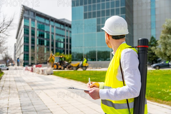 Horizontal photo with copy space of an architect supervising remodeling works in the city