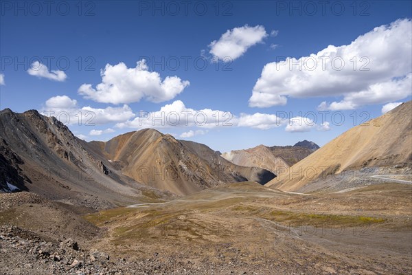 Mountain road through a colourful mountain landscape, view from the Chong Ashuu Pass, Tien Shan, Kyrgyzstan, Asia