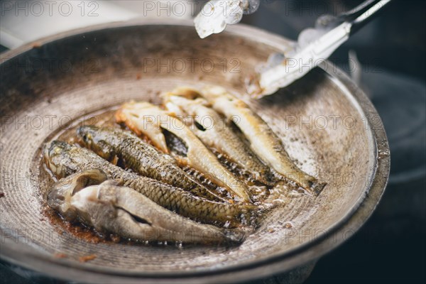 Close up to bolinao fish being fried showing the authentic filipino daily life, food and culture in the Philippines