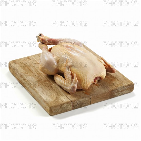 Raw whole chicken on a wooden cutting board, AI generated