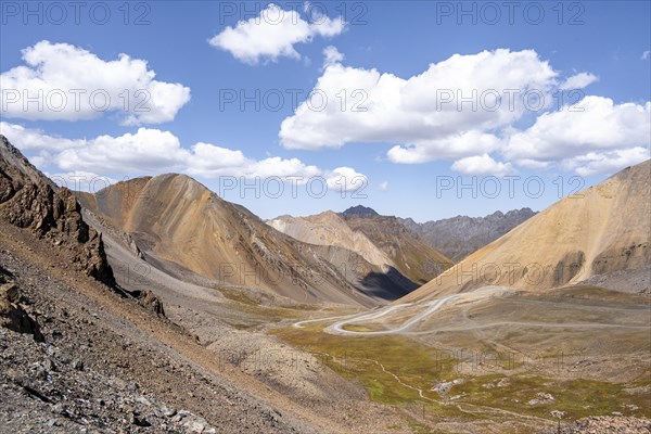 Mountain road through a colourful mountain landscape, view from the Chong Ashuu Pass, Tien Shan, Kyrgyzstan, Asia