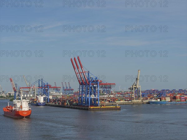 Container harbour with large cranes and ships in the water under blue sky, cranes and ships in a harbour, Hamburg, Germany, Europe