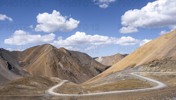 Mountain road through a colourful mountain landscape, view from the Chong Ashuu Pass, Tien Shan, Kyrgyzstan, Asia