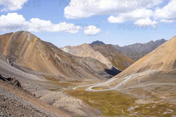 Mountain road through a colourful mountain landscape, view from the Chong Ashuu Pass, Tien Shan, Kyrgyzstan, Asia