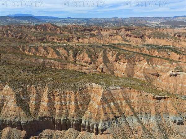 Red rocks and canyons stretch to the horizon under a clear blue sky, aerial view, Los Coloraos, Grand Canyon of Andalusia, Gorafe desert, Granada, Andalusia, Spain, Europe