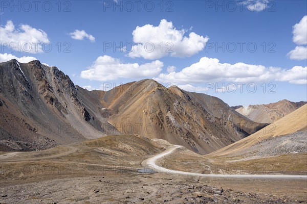Mountain road through a colourful mountain landscape, view from the Chong Ashuu Pass, Tien Shan, Kyrgyzstan, Asia