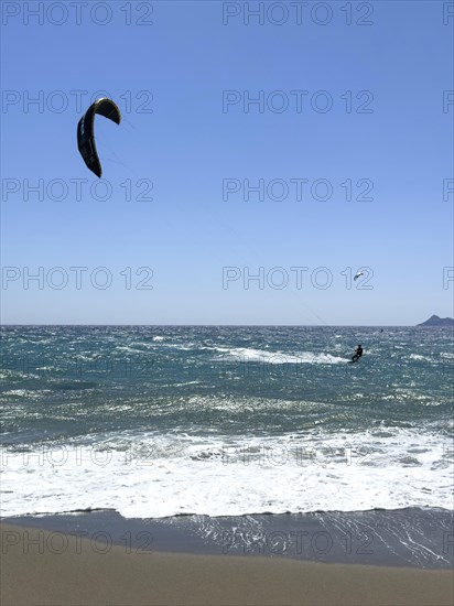Kitesurfer kite surfer surfing in strong wind and waves rough sea choppy sea with inflated sail, Kalamaki, Crete, Greece, Europe