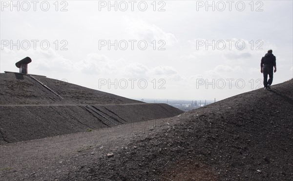 A walker on the Rungenberg slag heap in Gelsenkirchen, Gelsenkirchen, North Rhine-Westphalia, Germany on 12 April 2015