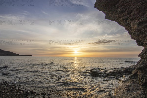 Sunrise with sea view in a lonely bay. rocky coast in warm colours. Landscape with a lava stone beach of Tarajalejo on Fuerteventura, Canary Islands, Spain, Europe