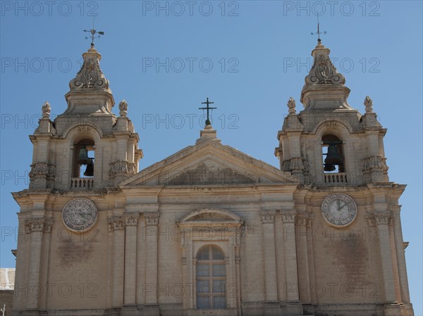 Front view of a historic church with two bell towers and clocks, the town of mdina on the island of malta with historic houses, colourful balconies, magnificent churches, mdina, Malta, Europe