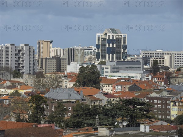 Urban landscape with modern high-rise buildings, low roofs and trees in an urban neighbourhood, old town with historic houses and red roofs in poertugal, porto, portugal