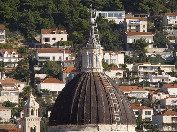 Large dome surrounded by traditional houses on a wooded hill, the old town of Dubrovnik with historic houses, churches, red roofs and fortress walls, dubrovnik, coratia