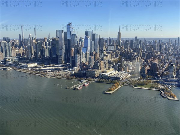 City view by day with skyscrapers and river in the foreground under a clear sky, the skyline of new york with impressive skyscrapers on the hudson river, new york, usa