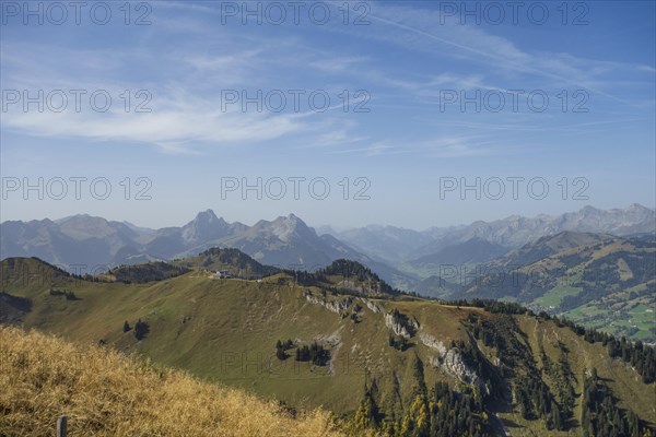 Vast mountain landscape with meadows and wooded hills under a clear sky, peaceful atmosphere, mountain panorama with rugged mountains and green valleys, saas fee, Switzerland, Europe
