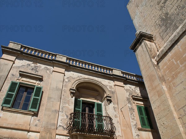 Facade of an old building with green shutters and decorative balcony, the town of mdina on the island of malta with historic houses, colourful balconies, magnificent churches, mdina, Malta, Europe