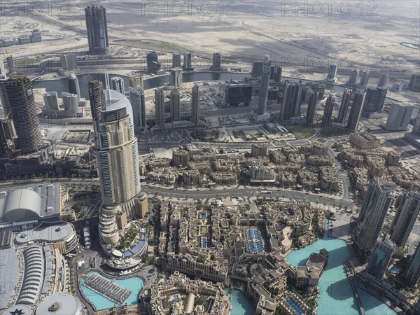 Wide angle shot of an urban skyline with modern architecture and water in the foreground, Dubai, Arab Emirates