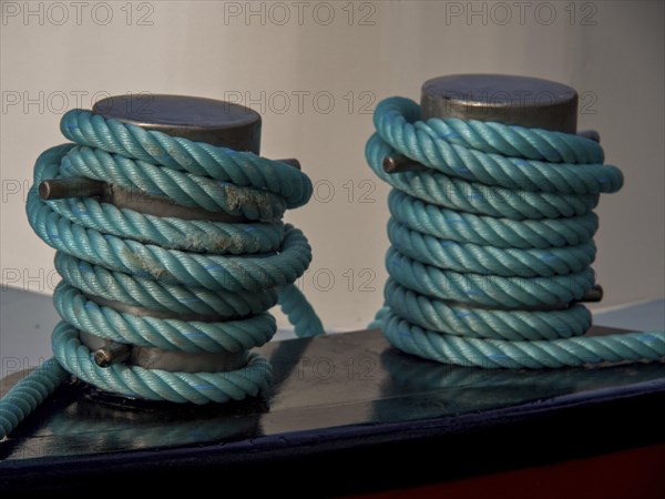 Close-up of two blue-wrapped mooring lines on a boat, historic houses in Hoorn and ships in the harbour, hoorn, the netherlands
