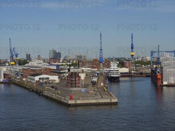 Industrial harbour area with cranes and ships in the water under a clear sky, Gorse city on the river with harbour, shipyards, houses and ships, Hamburg, Germany, Europe