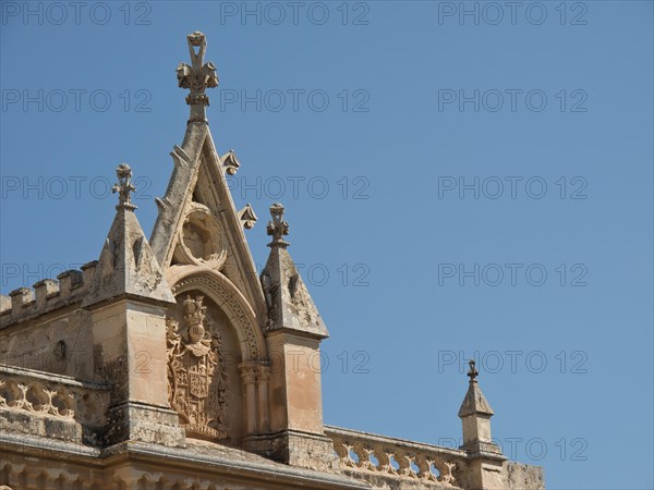 Ornate church facade with artistic decorations under a clear sky, the town of mdina on the island of malta with historic houses, colourful balconies, magnificent churches, mdina, Malta, Europe