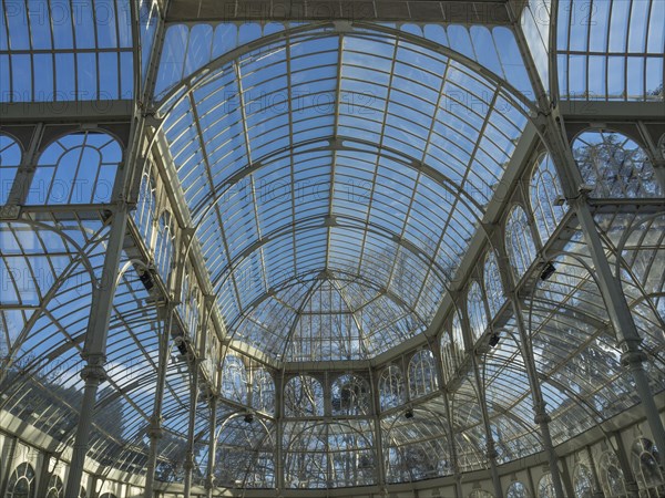 Beautiful architecture with a large glass roof and a dome that rises against the blue sky, Madrid, Spain, Europe