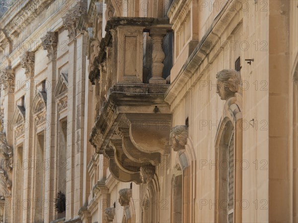 Side view of a historic building with decorative sculptures and balconies, the town of mdina on the island of malta with historic houses, colourful balconies, magnificent churches, mdina, Malta, Europe