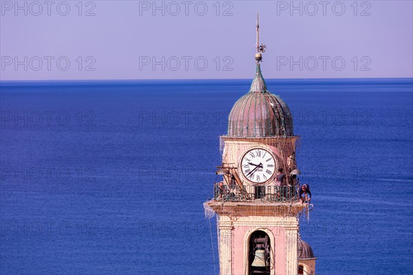 Workers at the top of Church of Santa Maria Assunta, Camogli, Liguaia, Italy, Europe