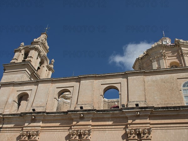 Baroque church with sandstone bell tower under a clear sky, the town of mdina on the island of malta with historic houses, colourful balconies, magnificent churches, mdina, Malta, Europe
