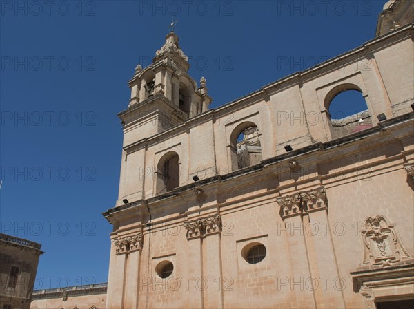 Partial view of a historic church with a tower and a bright blue sky, the town of mdina on the island of malta with historic houses, colourful balconies, magnificent churches, mdina, Malta, Europe