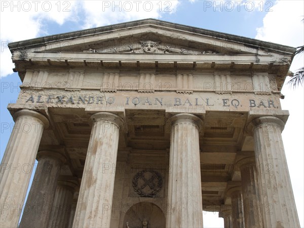 Ancient temple with columns and inscription under a blue sky, Valetta, Malta, Europe