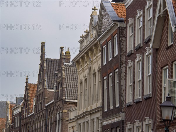 Historic buildings in an old town with ornate facades and tiled roofs, historic houses in Hoorn and ships in the harbour, hoorn, the netherlands
