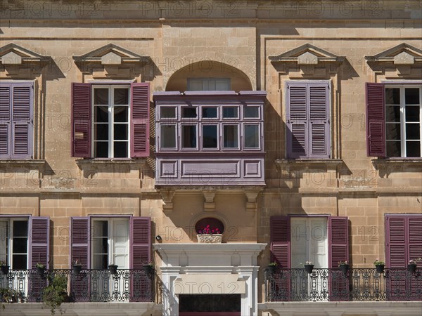 Building facade with purple shutters and small balconies, the town of mdina on the island of malta with historic houses, colourful balconies, magnificent churches, mdina, Malta, Europe