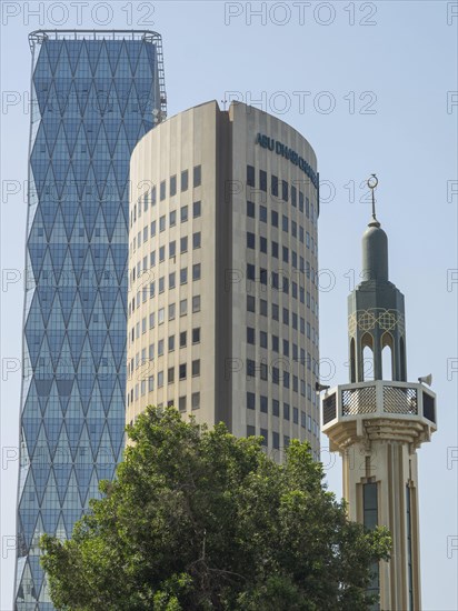 Modern skyscrapers and minaret in Abu Dhabi, sky and trees in the background, Abu Dhabi, United Arab Emirates, Asia