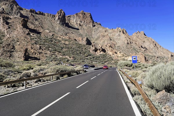 On the way to Mount Teide, El Teide, Pico del Teide, volcano in the Teide National Park on Tenerife, Canary Islands, Spain, Europe, country road leading through a mountainous landscape with cars, vegetation and clear skies, Tenerife, Europe