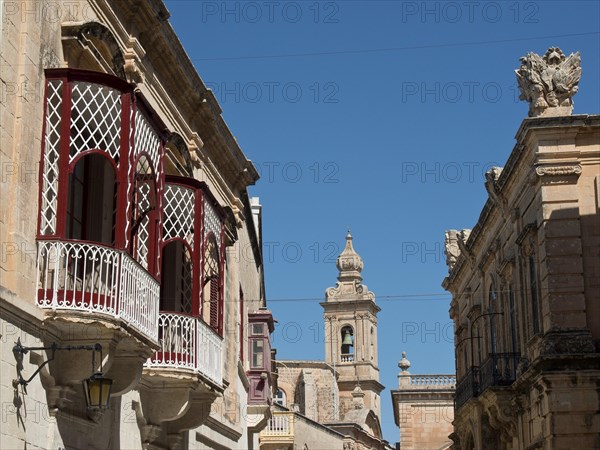 Street scene with traditional balconies and view of the bell tower in the background, the town of mdina on the island of malta with historic houses, colourful balconies, magnificent churches, mdina, Malta, Europe