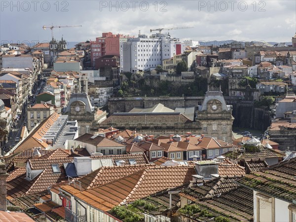 A city view with many red roofs and historic buildings in the background, historic buildings and monuments in the old town centre of porto, porto, portugal