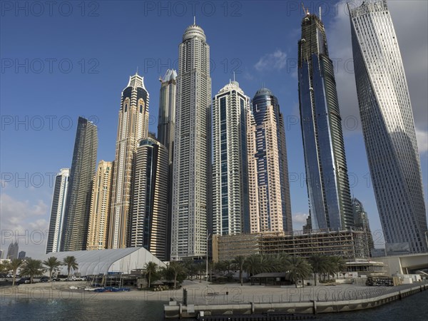 Wide angle view of a dense skyline of modern skyscrapers in sunny weather, dubai, arab emirates