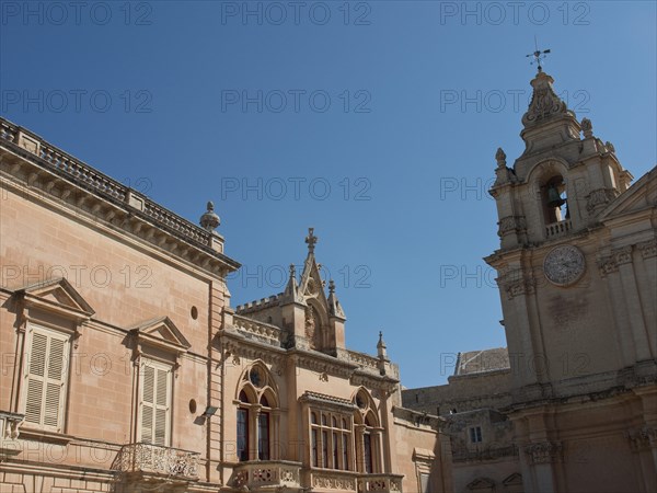 Historic buildings and a bell tower under a clear blue sky, the town of mdina on the island of malta with historic houses, colourful balconies, magnificent churches, mdina, Malta, Europe