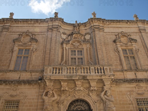 Baroque building with ornate facades, windows and statues under a slightly cloudy sky, the town of mdina on the island of malta with historic houses, colourful balconies, magnificent churches, mdina, Malta, Europe