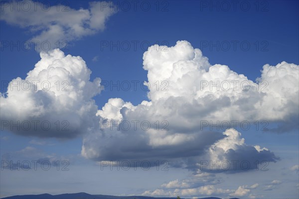 Large cumulus clouds over the mountains of the Bavarian Forest near Deggendorf, Lower Bavaria, Germany, Europe