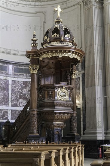 Interior view of Berlin Cathedral, Berlin, Germany, Europe, Magnificent pulpit with detailed wooden decorations and golden accents in a sacred setting, Europe