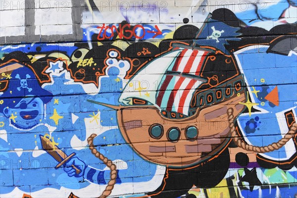 Barcelona, Catalonia, Spain, Europe, Imaginative graffiti of a cartoon ship with bright colours on a wall, Europe