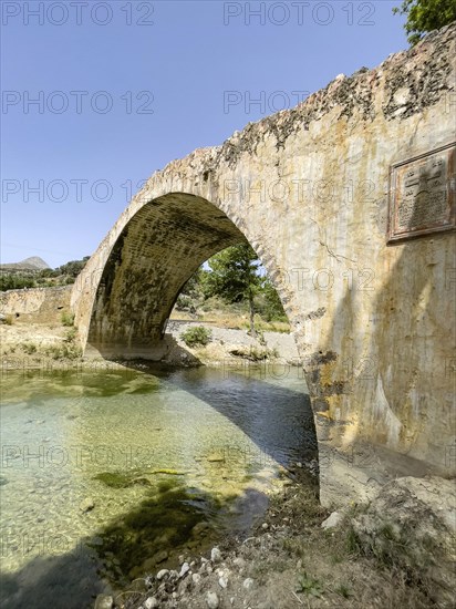 Historic classical stone arch bridge in Venetian architectural style Venetian Great Old Bridge 19th century stone bridge built in 1850 in Ottoman times over the middle reaches of the Megalopotamos River at Preveli, Agios Vasilios, Crete, Greece, Europe