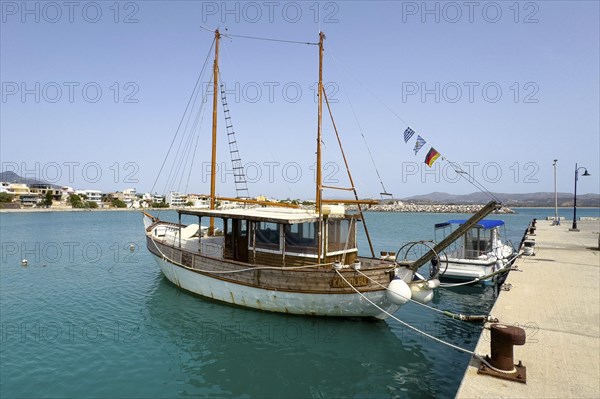 Old wooden sailing boat moored to quay wall in Kokkinos Pyrgos harbour, Kokkinos Pyrgos, Crete, Greece, Europe