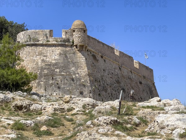 Fortress wall with one of 10 ten watchtowers on east side of fortress ruins of historic fortress Fortetza Fortezza of Rethymno built by Republic of Venice in 16th century in northwest of old town of Rethymno on rocky hill Paleokastro on north coast of island Crete, Rethymno, Crete, Greece, Europe