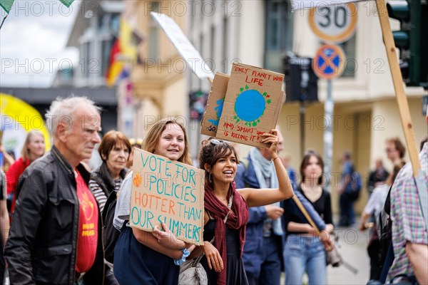 Demonstrators with signs at Fridays for Future, taken during the climate strike for the EU elections in Berlin, 31/05/2024