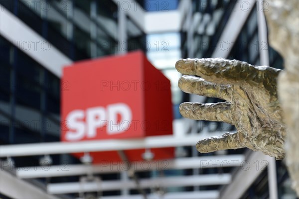 Large, sculpted hand in the foreground, SPD lettering and modern glass architecture in the background, Willy Brandt House, SPD headquarters, Berlin, Berlin, Germany, Europe