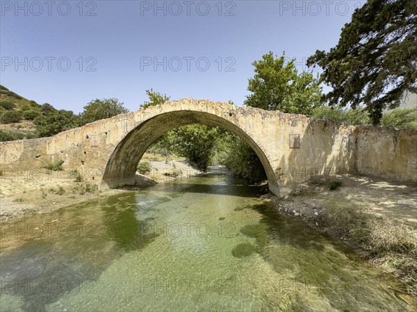 Frontal view of historic classical arched stone bridge in Venetian architectural style Venetian Great Old Bridge 19th century stone bridge built in 1850 in Ottoman times over the middle reaches of Megalopotamos River at Preveli, Agios Vasilios, Crete, Greece, Europe